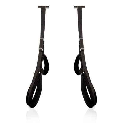 Black door sex swing with padded straps for bondage play.