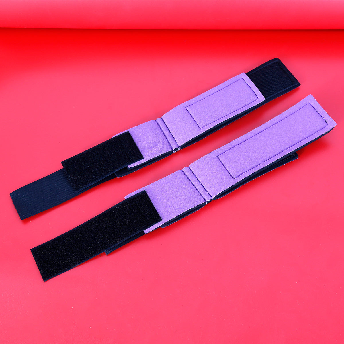 Soft adjustable positioning cuffs for wrists and ankles used to elevate legs during sex.