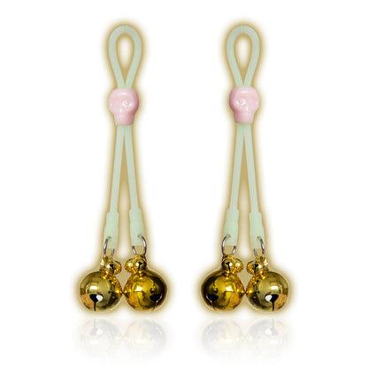Glow-in-the-dark adjustable nipple bells with gold jingle bells and skull accent.